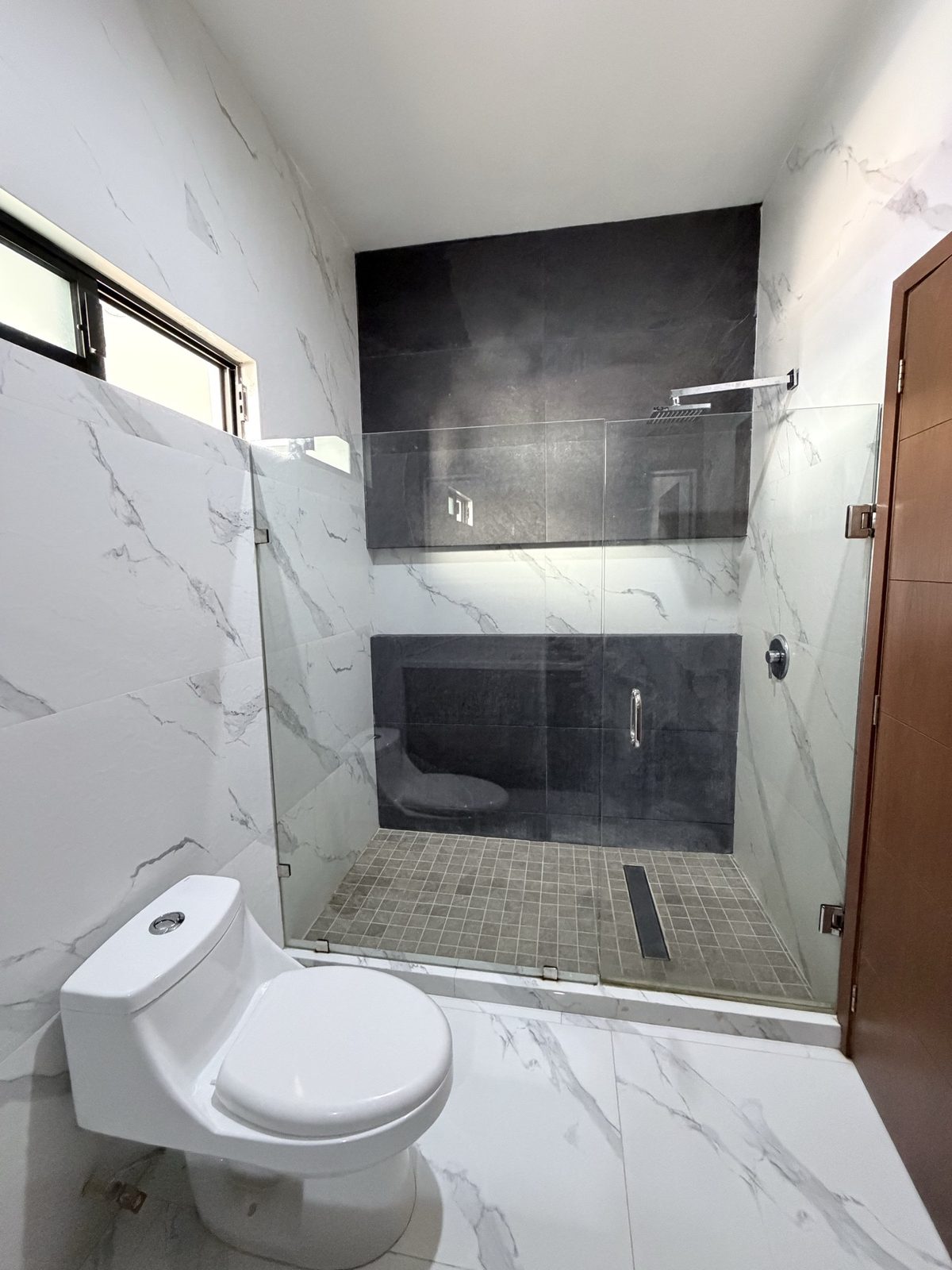 Baño completo con porcelanato gris y blanco en casa en renta en Soles Parque Residencial