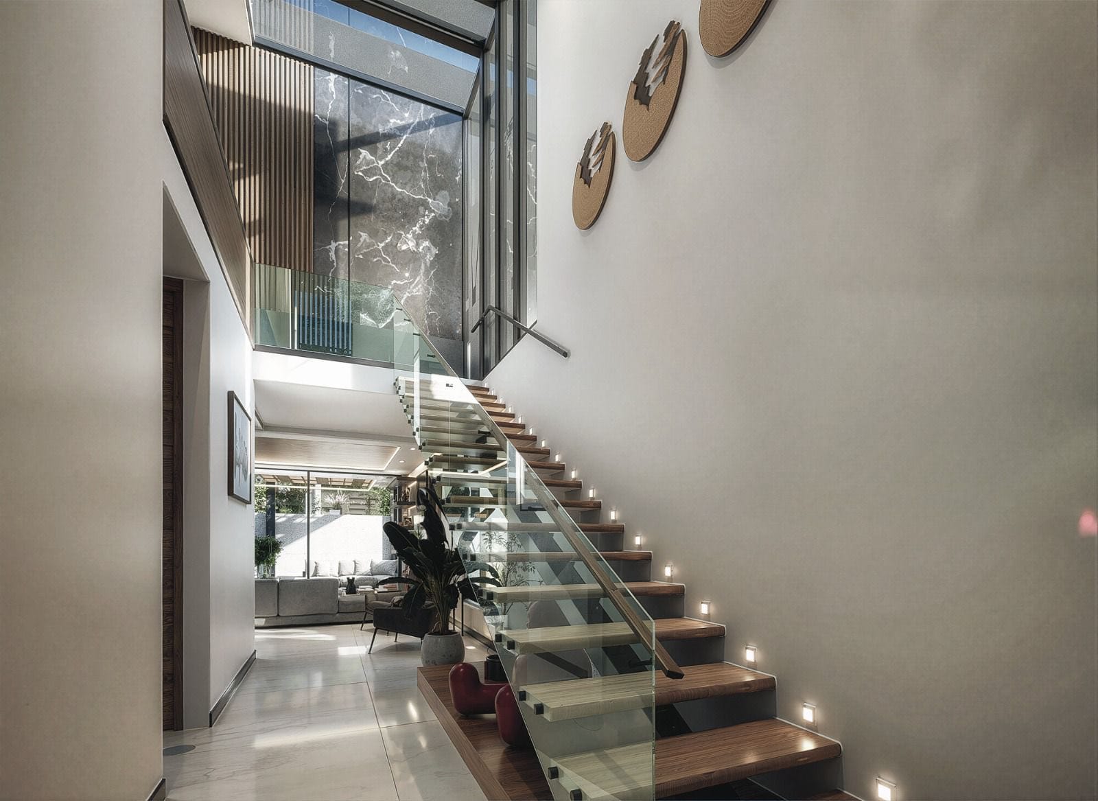 Escalera de doble altura iluminada en casa de Paraíso Marina